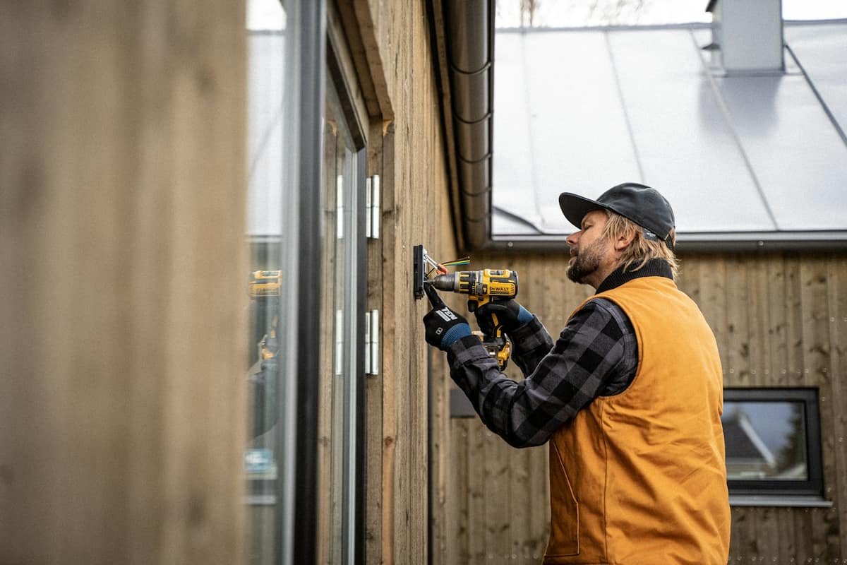 Electrician with a drill on a job site